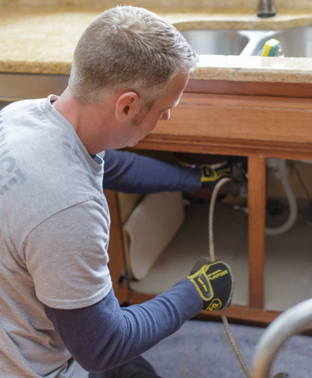 Sewer and Drain Cleaning - Snaking out pipe under sink
